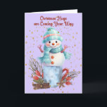 Snowman Hugs Christmas Cards<br><div class="desc">Snowman hugs Christmas card with a cute snowman standing on a container with decorations surrounding it.  The words on the inside can be changed.</div>