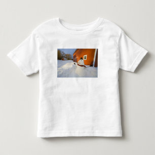 Snowman in front of red barn in Columbia Falls Toddler T-Shirt
