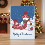 Snowman Knitting Christmas Scarf Holiday Card<br><div class="desc">Cartoon illustration of two adorable snowmen dressed in knitted hats and scarves. The big snowman is knitting an oversized scarf for the little one. The scarf is already wrapped several times around the cute little snowman. Customizable text.</div>