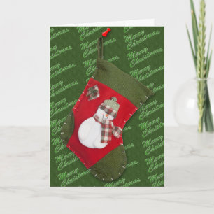 Snowman on Christmas Stocking Over Green Holiday Card