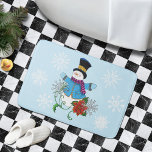 Snowman Snowflakes Poinsettia Bath Mat<br><div class="desc">A charming snowman, warmly dressed in a bright blue coat and light blue mittens, arms open wide as if inviting you to share in the joy of the season. Topping off the look is a classic black top hat. Beside the snowman, two large snowflakes and a vibrant red poinsettia that...</div>