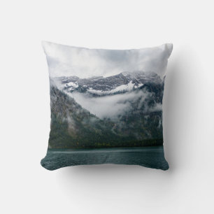 Snowy mountains in the fog at Plansee lake Cushion