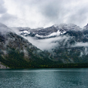 Snowy mountains in the fog at Plansee lake   Watch