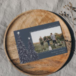 Snowy Pines | Elegant Christmas Photo Holiday Card<br><div class="desc">A modern and elegant Christmas holiday card design featuring a horizontal photo on a navy blue background adorned with pine trees laden with snow and topped with white stars. Personalise with your custom holiday greeting,  family name and the year.</div>
