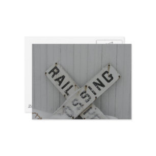 Snowy Rail Crossing Sign in Front of White Barn Postcard