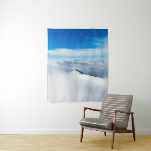 Snowy winter mountain wrapped in clouds tapestry