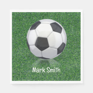 Soccer ball on green grass napkin