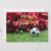 Soccer ball with Christmas decoration on green