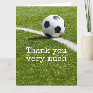 Soccer ball with word Thank you on green grass