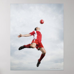Soccer player and soccer ball in mid-air poster
