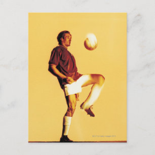 soccer player bouncing ball off knee postcard