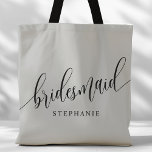 Soft Grey Bridesmaid Modern Script Tote Bag<br><div class="desc">Show your appreciation to your bridal party with this stylish soft grey bridesmaid tote bag. Featuring modern script and customisable with your bridesmaid's name, this tote bag is both practical and elegant. The soft colour and chic design make it perfect for carrying wedding day essentials or everyday items. This personalised...</div>