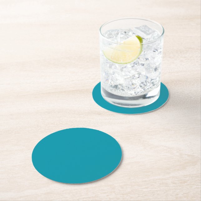 Solid colour seaside teal round paper coaster (Insitu)