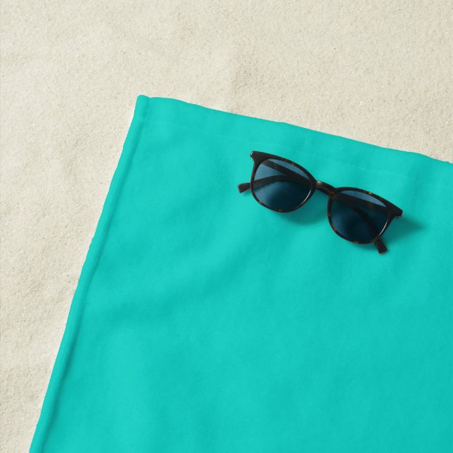 Solid plain bright turquoise beach towel (In Situ)