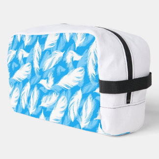 Sophisticated Feather Design On A Bright Blue Dopp Kit