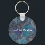 Space Explorer Key Ring<br><div class="desc">This inspirational keychain,  featuring a hand-painted galaxy filled with stars and planets ad featuring the phrase "reach for the stars" makes a wonderful gift. Text is fully customisable. Part of a collection from Parcel Studios.</div>