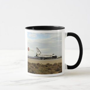 Space Shuttle Discovery deploys its drag chute Mug