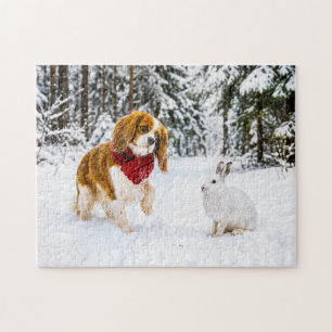 Spaniel meets snow hare in winter forest jigsaw puzzle