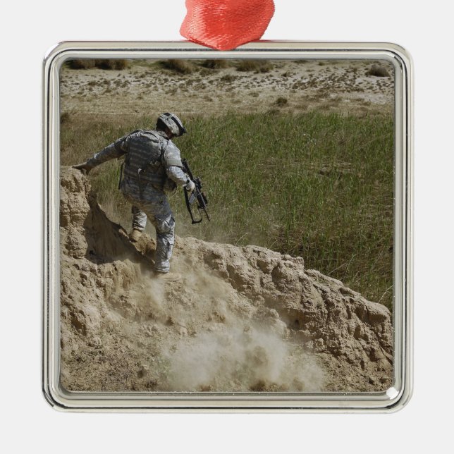 Specialist climbs down metal tree decoration (Front)