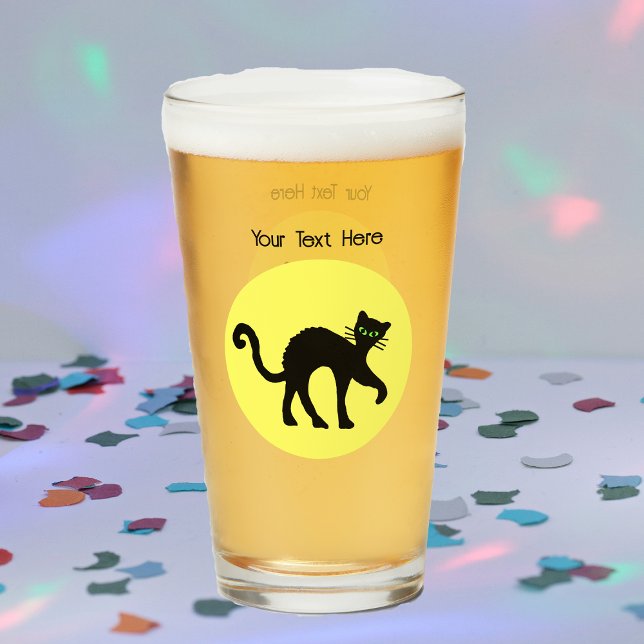 Spooky Black Cat Arched Back Full Yellow Moon Glass (Black Cat arched back green eyes against full yellow moon on glass drink tumbler.)