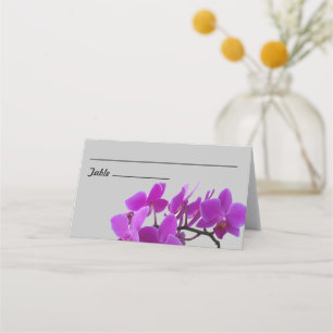 Spray of fuchsia orchids on folded placecard