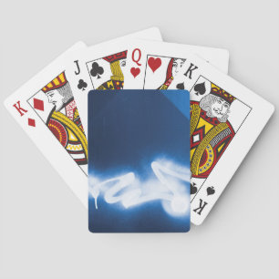 Sprayed graffiti on blue metal playing cards
