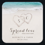 Spread Love Hearts in the sand beach wedding favou Square Sticker<br><div class="desc">Spread love not germs wedding favours features two hearts in the sand and couple's names and date on turquoise water and white sand beach background,   great for summer beach wedding,  or tropical destination wedding. 
See all the matching pieces in collection</div>