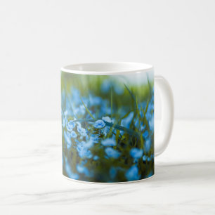 Spring flowers on field coffee mug