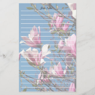 spring pink magnolia flowers in blue sky stationery