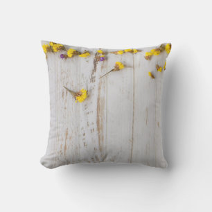 Spring yellow flowers, white plank decor. cushion