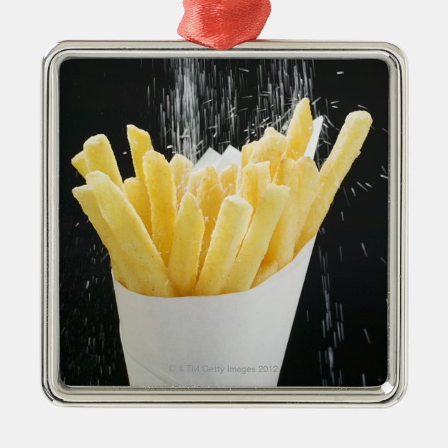 Sprinkling salt on chips in paper cone metal tree decoration (Front)