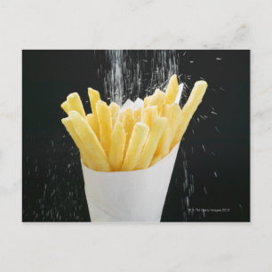 Sprinkling salt on chips in paper cone postcard