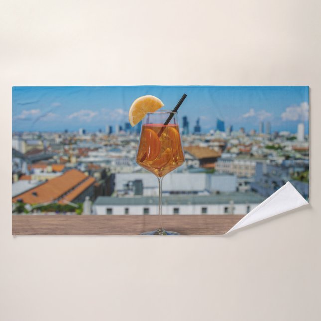 Spritz cocktail on a table with view of Milan Bath Towel (Bath Towel)