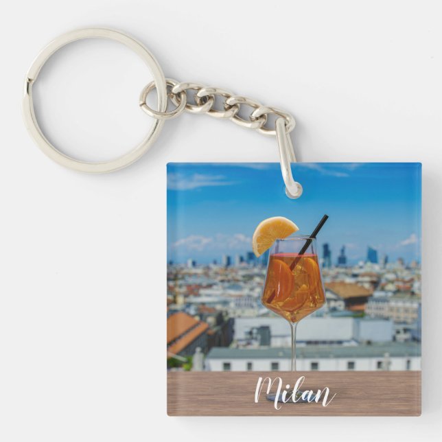 Spritz cocktail on a table with view of Milan Key Ring (Front)