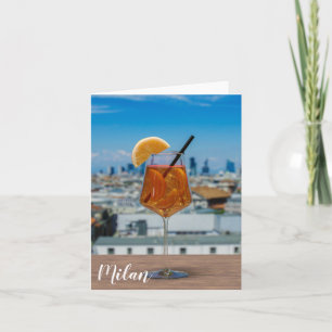 Spritz cocktail on a table with view of Milan Note Card