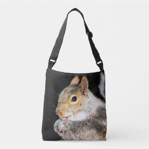 Squirrel eating a nut crossbody bag