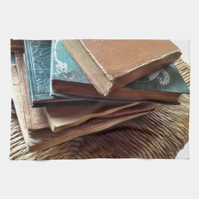 Stack of books on old chair tea towel (Horizontal)