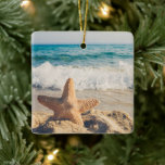 Starfish on a Sandy Beach Photograph Ceramic Ornament<br><div class="desc">An ornament with a scenic photo. A big starfish set upright on a sandy beach. A beautiful blue sea with waves of white surf in the background.</div>