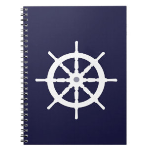 Steering wheel on navy blue background. spiral notebook