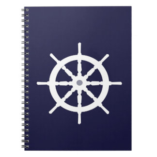 Steering wheel on navy blue background. spiral notebook