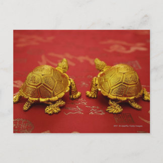 Still life of a pair of gold tortoise figurines postcard
