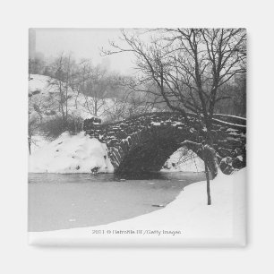 Stone bridge over snow covered river magnet