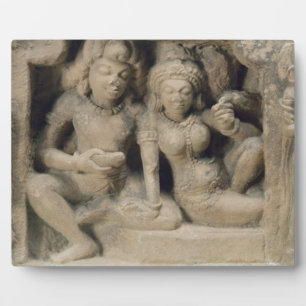 Stone carving of lovers enjoying a dance performan plaque