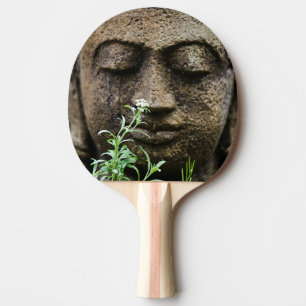 Stone garden statue with flower ping pong paddle
