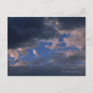 Storm clouds against blue sky postcard
