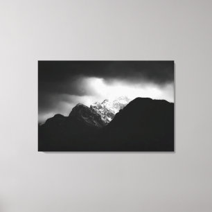 Storm clouds and sun over mountains canvas print
