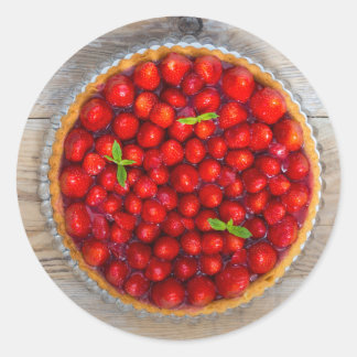 Strawberry cake with mint leaves on a rustic wood classic round sticker