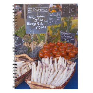 Street market merchant's stall with white spiral notebook