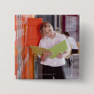 Student removing binder from school locker 15 cm square badge