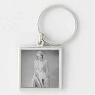 Studio portrait of young woman in nightgown key ring
